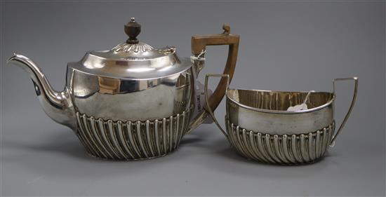 A silver teapot of oval half-fluted form and a matching sucrier, London 1900, maker Samuel Walton Smith, gross 21 oz.